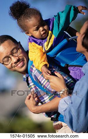 Father carrying his daughter on his back View Large Photo Image Stock Photography - Father carrying his daughter on his back. Fotosearch