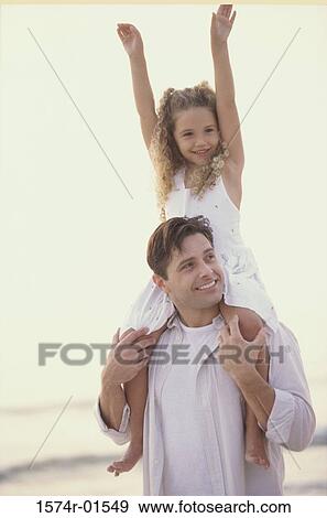 Stock Photo - Father carrying his daughter on his shoulders. Fotosearch