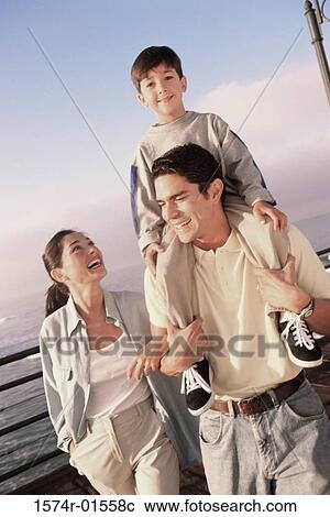 Father carrying his son on his shoulders View Large Photo Image Stock Image - Father carrying his son on his shoulders. Fotosearch