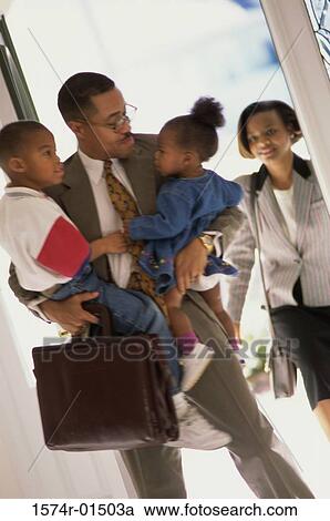 Stock Image - Father holding his children. Fotosearch