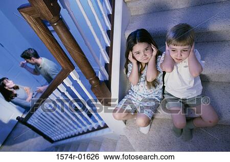 High angle view of a boy and girl listening to their parents fight View Large Photo Image Stock Photograph - High angle view of a boy and girl listening to their parents fight. Fotosearch