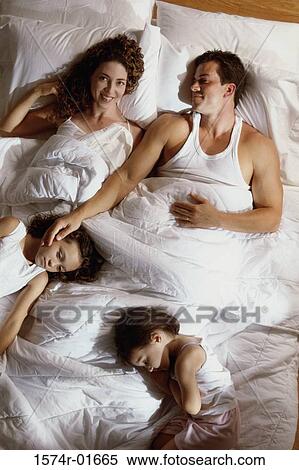 Stock Photography - High angle view of a couple in bed with their son and daughter. Fotosearch