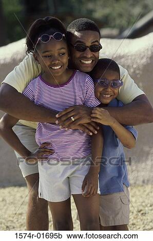 Man hugging his son and daughter on the beach View Large Photo Image Stock Image - Man hugging his son and daughter on the beach. Fotosearch