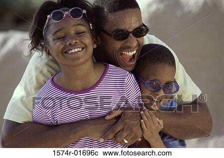 Man hugging his son and daughter on the beach View Large Photo Image Stock Image - Man hugging his son and daughter on the beach. Fotosearch