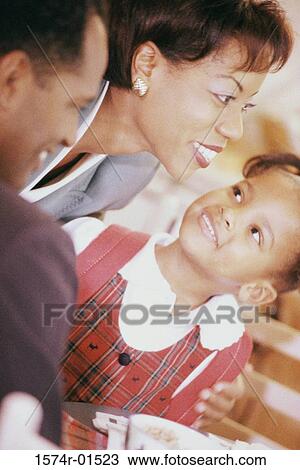 Parents and their daughters smiling View Large Photo Image Stock Image - Parents and their daughters smiling. Fotosearch