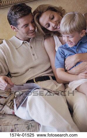 Parents and their son sitting together in bed View Large Photo Image Stock Photography - Parents and their son sitting together in bed. Fotosearch