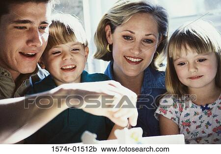 Stock Image - Parents and their two children smiling. Fotosearch