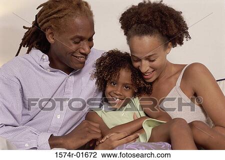 Portrait of a couple holding their daughter View Large Photo Image Stock Image - Portrait of a couple holding their daughter. Fotosearch