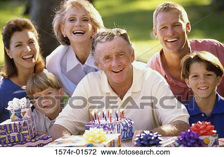 Portrait of a family celebrating a birthday outdoors View Large Photo Image Stock Image - Portrait of a family celebrating a birthday outdoors. Fotosearch