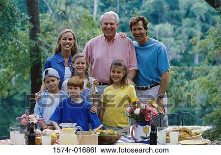 Stock Image - Portrait of a family standing together at a picnic. Fotosearch