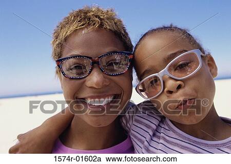 Stock Image - Portrait of a mother and daughter on the beach. Fotosearch