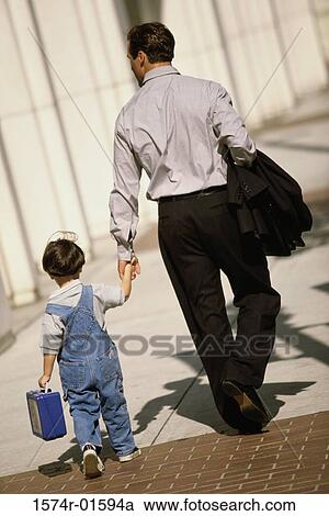 Rear view of a father walking with his son View Large Photo Image Stock Image - Rear view of a father walking with his son. Fotosearch