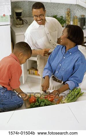 Son helping his mother in the kitchen View Large Photo Image Stock Image - Son helping his mother in the kitchen. Fotosearch