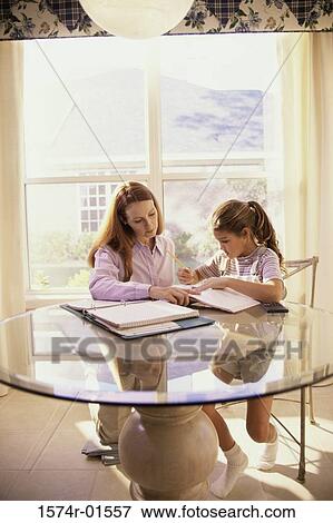 Woman tutoring her daughter View Large Photo Image Stock Photo - Woman tutoring her daughter. Fotosearch