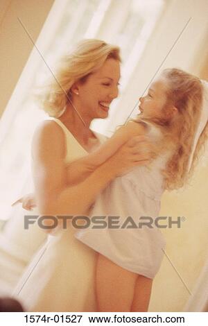 Young woman lifting up her daughter View Large Photo Image Stock Photo - Young woman lifting up her daughter. Fotosearch