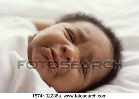 Stock Image - Close-up of a baby boy crying. Fotosearch