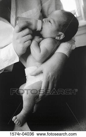 Close-up of a baby boy drinking milk from a feeding bottle View Large Photo Image Stock Photograph - Close-up of a baby boy drinking milk from a feeding bottle. Fotosearch