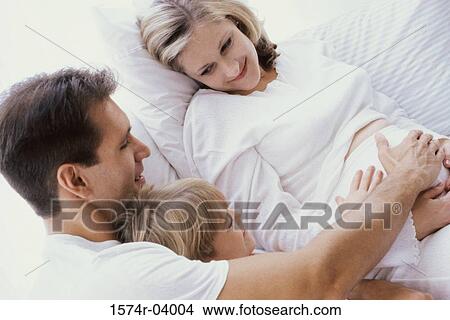 Close-up of a father and his son touching a pregnant woman' s abdomen View Large Photo Image Picture - Close-up of a father and his son touching a pregnant woman' s abdomen. Fotosearch
