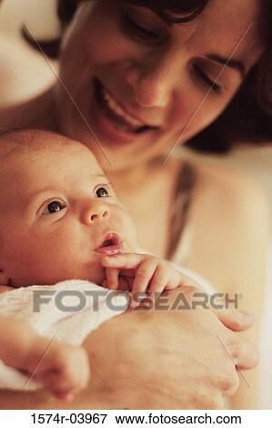 Close-up of a mother carrying her baby boy View Large Photo Image Stock Photo - Close-up of a mother carrying her baby boy. Fotosearch