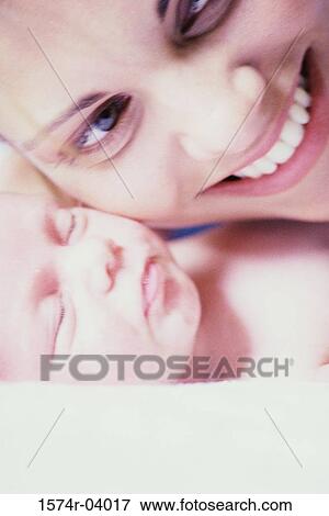 Close-up of a mother carrying her baby boy View Large Photo Image Stock Photo - Close-up of a mother carrying her baby boy. Fotosearch