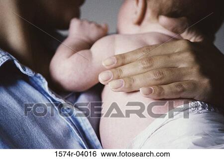 Close-up of a mother carrying her baby boy View Large Photo Image Stock Photograph - Close-up of a mother carrying her baby boy. Fotosearch
