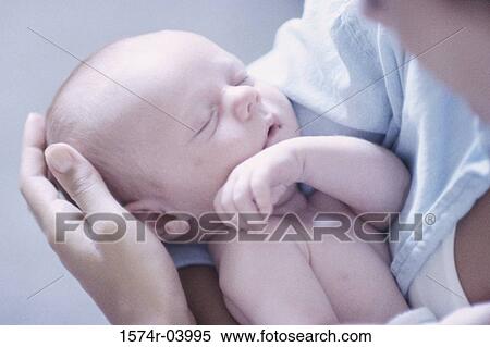Close-up of a mother carrying her baby boy View Large Photo Image Stock Photography - Close-up of a mother carrying her baby boy. Fotosearch