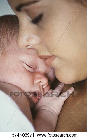 Close-up of a mother holding her baby boy View Large Photo Image Stock Image - Close-up of a mother holding her baby boy. Fotosearch