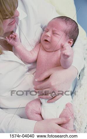 Close-up of a mother holding her baby boy View Large Photo Image Stock Image - Close-up of a mother holding her baby boy. Fotosearch
