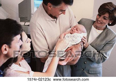 Grandparents carrying their baby boy in the hospital View Large Photo Image Stock Image - Grandparents carrying their baby boy in the hospital. Fotosearch