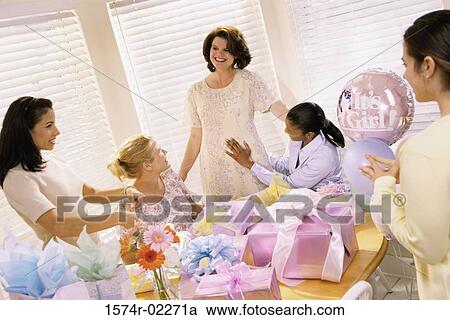 Stock Image - Group of young women at a baby shower. Fotosearch