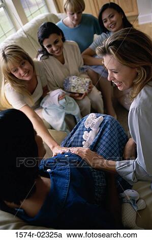 Group of young women sitting together at a baby shower View Large Photo Image Stock Image - Group of young women sitting together at a baby shower. Fotosearch