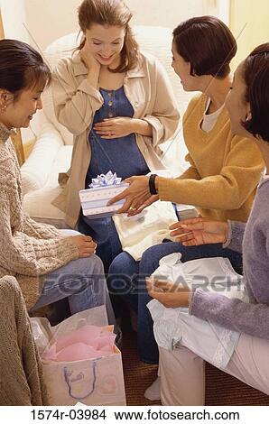 Group of young women with presents at a baby shower View Large Photo Image Picture - Group of young women with presents at a baby shower. Fotosearch