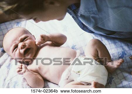 High angle view of a baby boy with his mother View Large Photo Image Stock Image - High angle view of a baby boy with his mother. Fotosearch