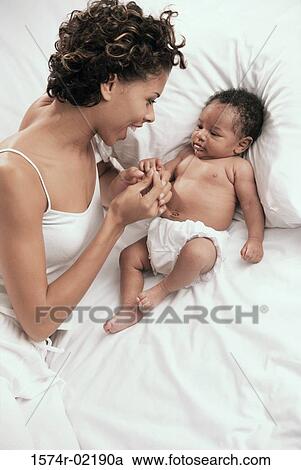 High angle view of a mother playing with her baby boy View Large Photo Image Stock Image - High angle view of a mother playing with her baby boy. Fotosearch