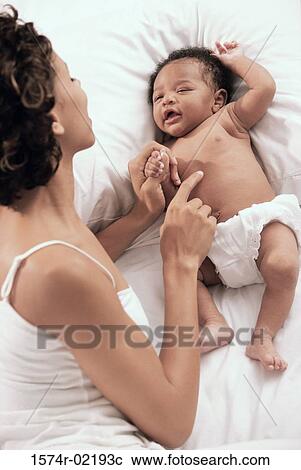 High angle view of a mother playing with her baby boy View Large Photo Image Stock Image - High angle view of a mother playing with her baby boy. Fotosearch