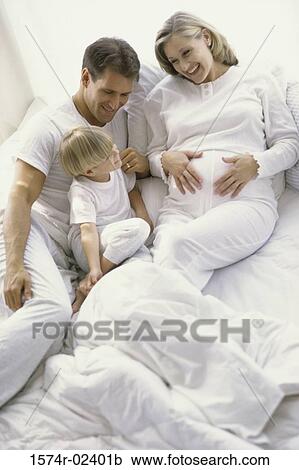 High angle view of a pregnant woman with her husband and son View Large Photo Image Stock Image - High angle view of a pregnant woman with her husband and son. Fotosearch