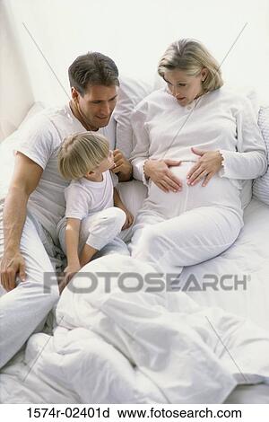 High angle view of a pregnant woman with her husband and son View Large Photo Image Stock Image - High angle view of a pregnant woman with her husband and son. Fotosearch