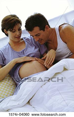 Husband lying in bed with his pregnant wife View Large Photo Image Stock Image - Husband lying in bed with his pregnant wife. Fotosearch