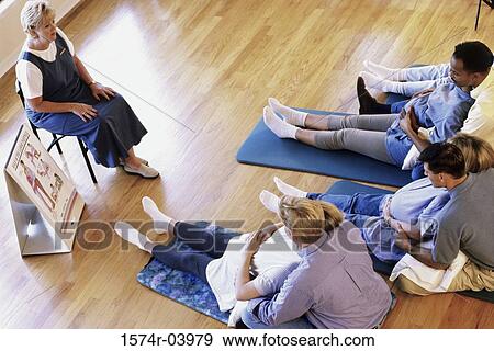 Stock Photo - Husbands and their pregnant wives at a prenatal class. Fotosearch