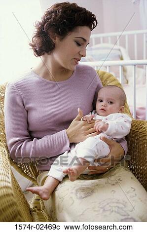 Mother carrying her baby girl View Large Photo Image Stock Image - Mother carrying her baby girl. Fotosearch