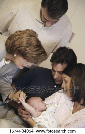 Picture - Parent carrying their baby boy with a senior man standing beside them. Fotosearch