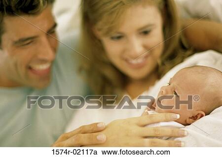 Parents carrying their baby boy View Large Photo Image Stock Image - Parents carrying their baby boy. Fotosearch
