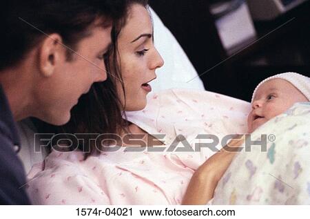Parents carrying their baby boy View Large Photo Image Stock Image - Parents carrying their baby boy. Fotosearch