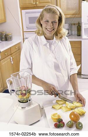 Portrait of a pregnant woman cutting fruit View Large Photo Image Stock Image - Portrait of a pregnant woman cutting fruit. Fotosearch