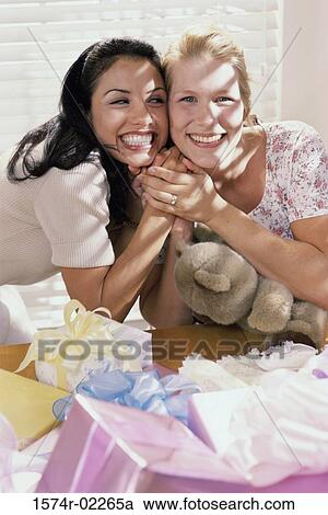 Portrait of two young women smiling at a baby shower View Large Photo Image Stock Image - Portrait of two young women smiling at a baby shower. Fotosearch