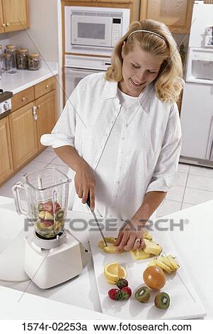 Pregnant woman cutting fruit View Large Photo Image Stock Image - Pregnant woman cutting fruit. Fotosearch