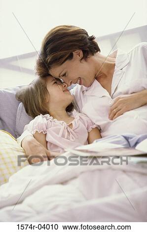 Pregnant woman nuzzling with her daughter View Large Photo Image Stock Image - Pregnant woman nuzzling with her daughter. Fotosearch