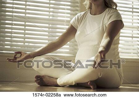 Pregnant woman sitting on the floor View Large Photo Image Stock Image - Pregnant woman sitting on the floor. Fotosearch