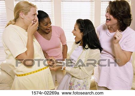 Young woman measuring a pregnant woman's abdomen View Large Photo Image Stock Image - Young woman measuring a pregnant woman's abdomen. Fotosearch