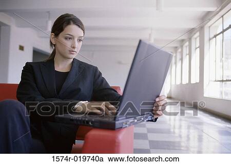 Close-up of a businesswoman using a laptop View Large Photo Image Stock Image - Close-up of a businesswoman using a laptop. Fotosearch